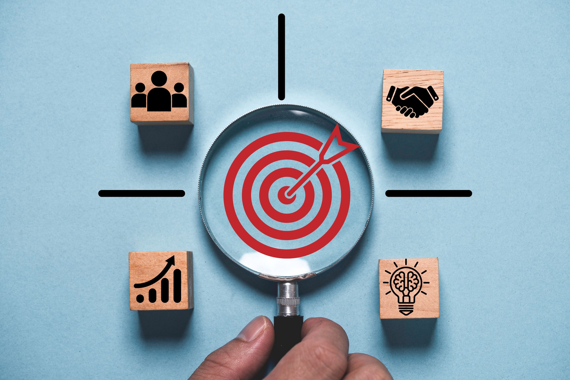 Objective target inside magnifier glass among business hand shake , humans idea and graph chart for focus. business achievement concept.